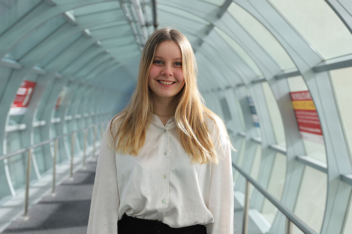 Jenna Nicodemus, recipient of the 2023 IU Indianapolis Division of Student Affairs Student Leader Scholarship, stands in a skywalk tunnel on the IU Indianapolis campus.